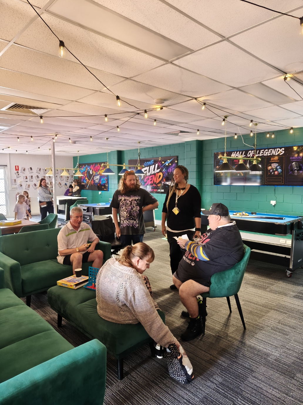 Guests chatting and playing board games in The Pulse lounge on Open Day